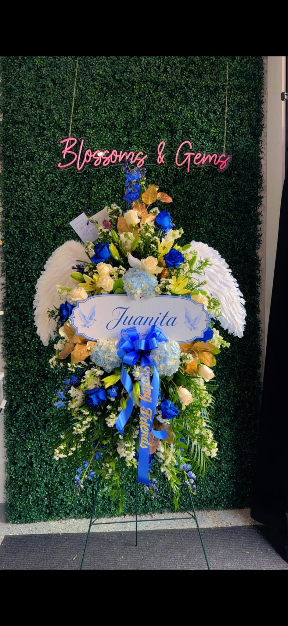 Angels Above standing spray — white feather angel wings with blue and white flowers