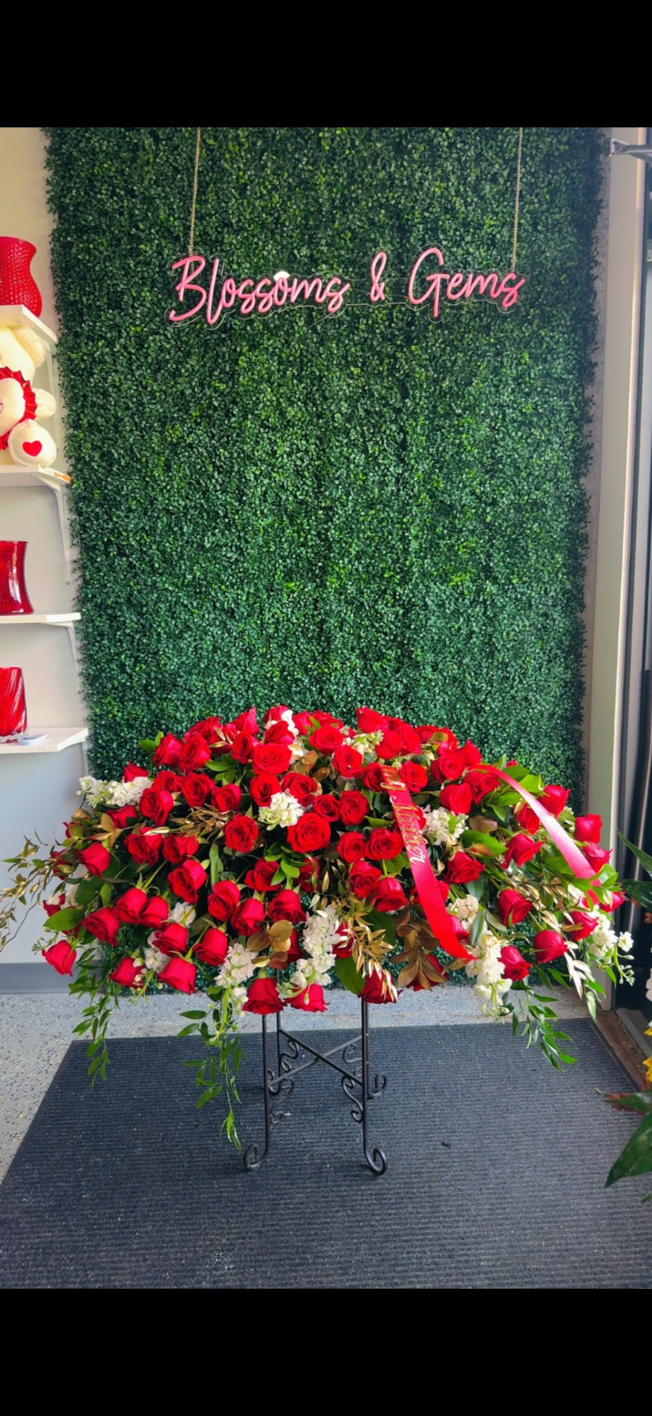 Full red rose casket spray designed by Blossoms & Gems