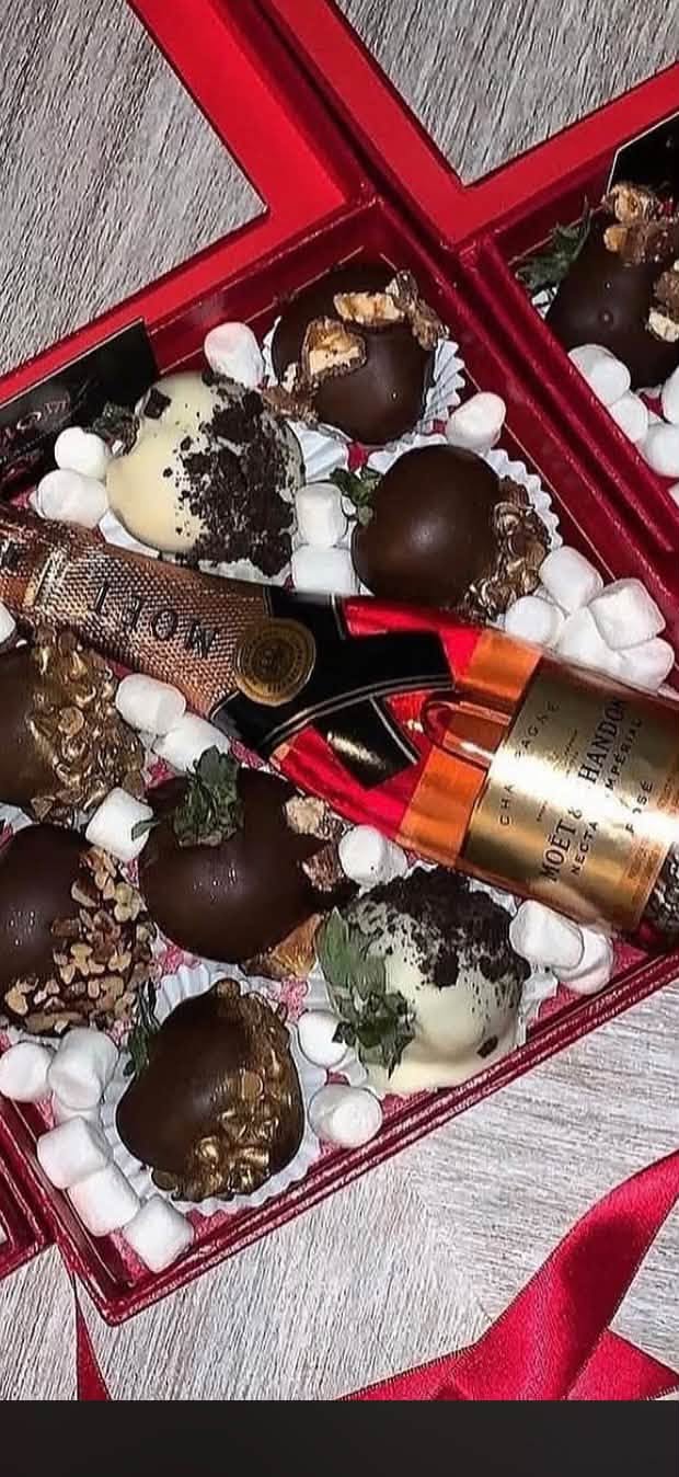 Gift box with chocolate-covered strawberries and a bottle, from the Blossoms & Gems gift shop