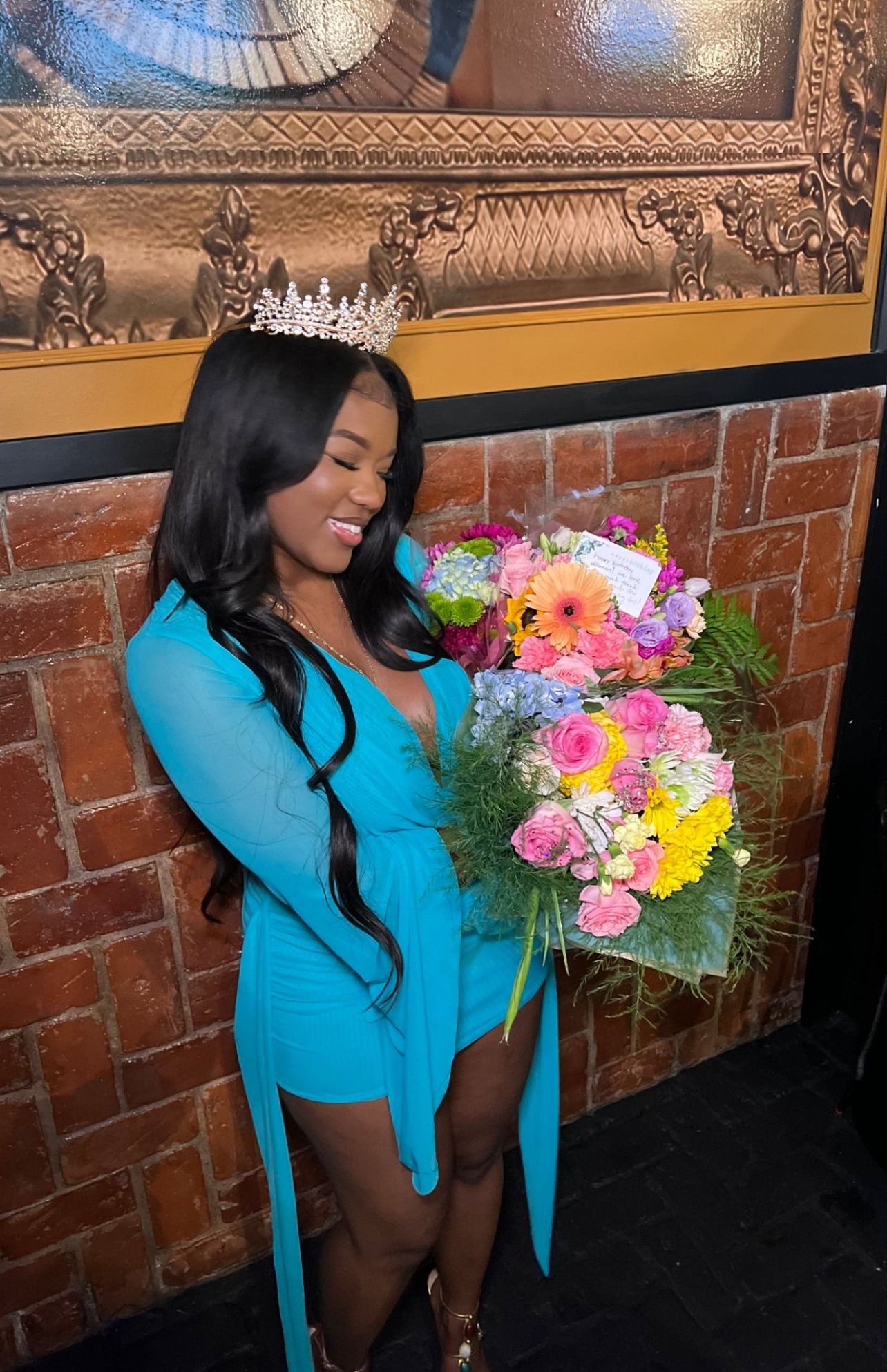 A Love in the Club delivery — a woman holding large colorful Blossoms & Gems bouquets