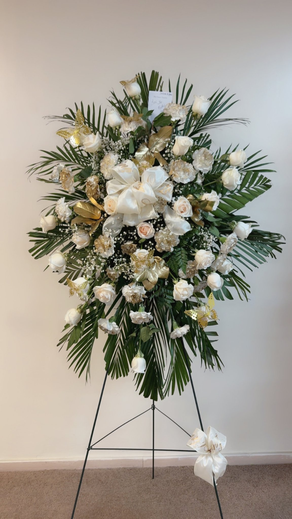White and gold standing spray with roses and butterflies, pictured in full