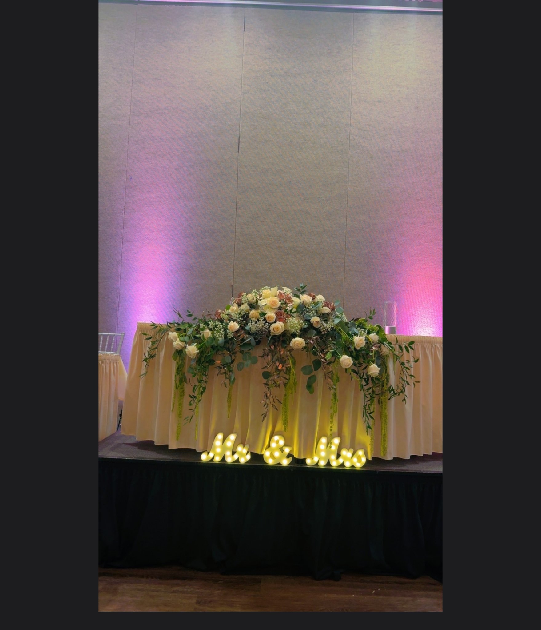 Wedding reception head table with white and cream flowers and Mr & Mrs lights, from Blossoms & Gems